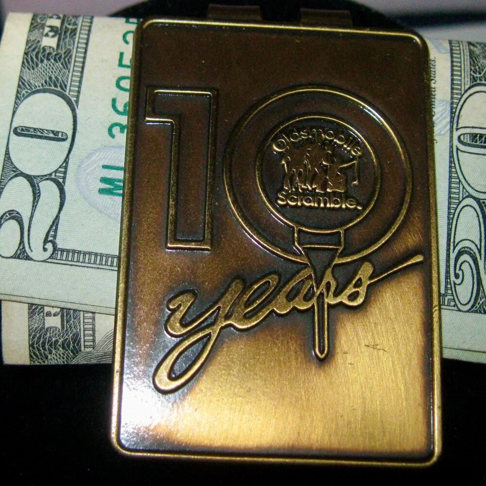 OLDSMOBILE SCRAMBLE 10 YEARS MONEY CLIP MADE IN USA 1993 (w/message on the back)